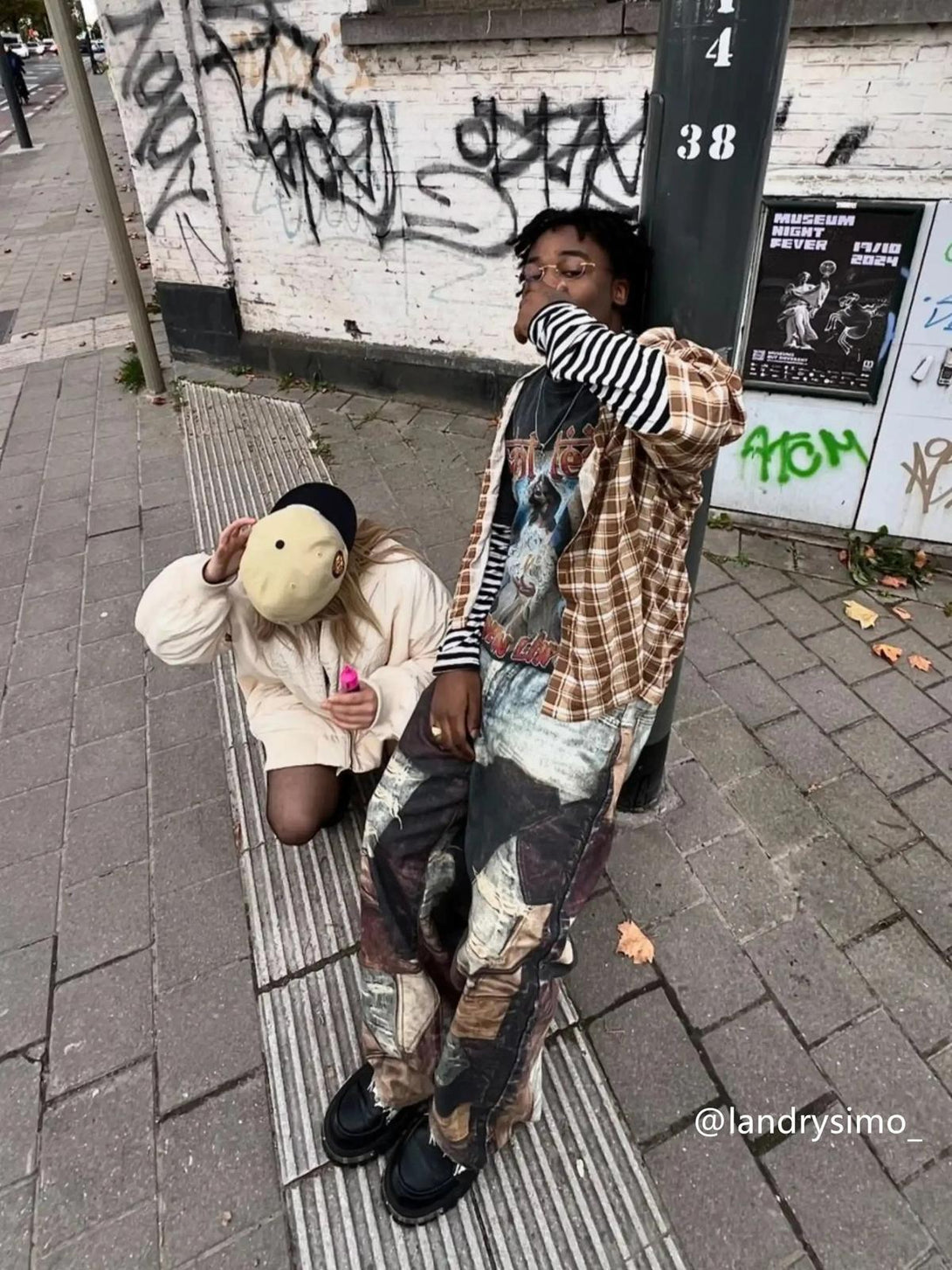 Street style vibe with TALISHKO distressed washed jeans featuring bold prints and layered tops.