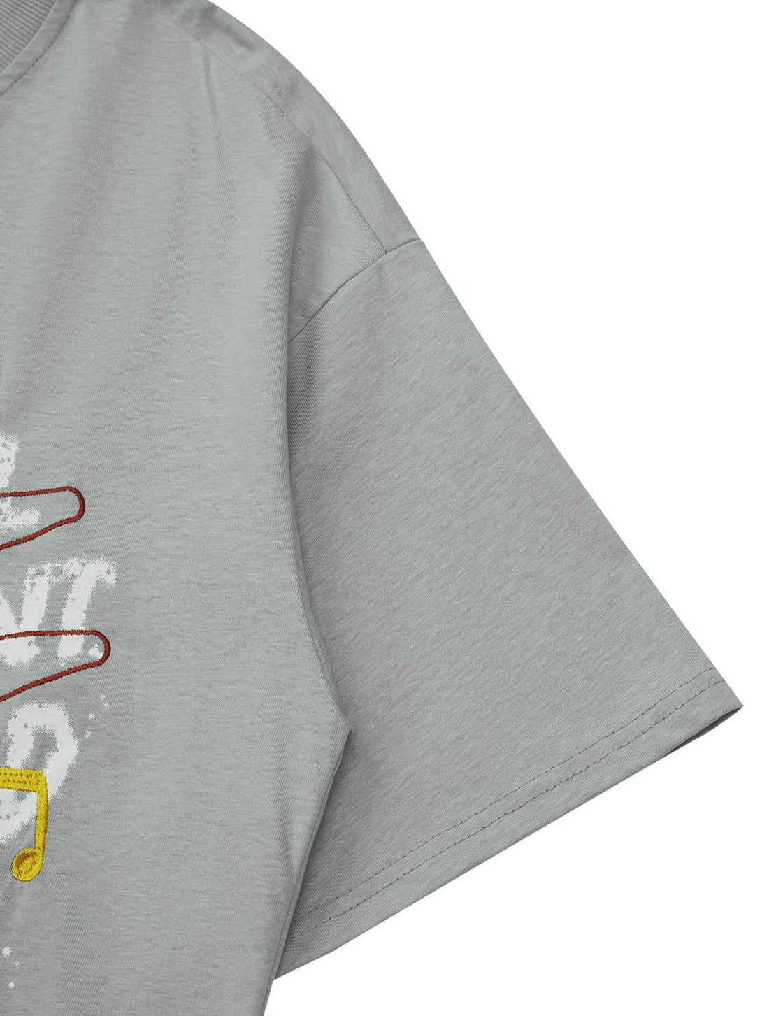 Detailed fabric and stitching of TALISHKO's gray T-shirt with creative embroidery accents.