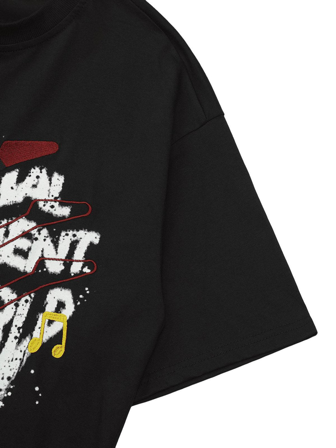 A tight crop highlighting TALISHKO's black T-shirt with bold graphic and embroidery details.