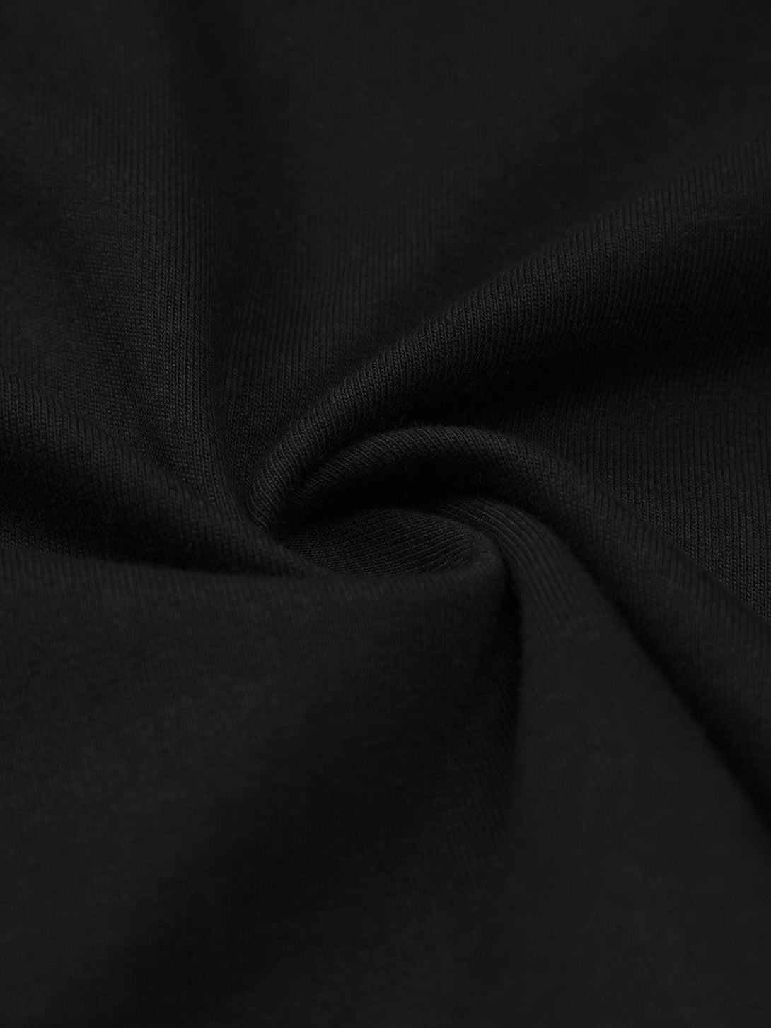 Texture and pattern showcased on TALISHKO's black T-shirt, emphasizing its smooth fabric.