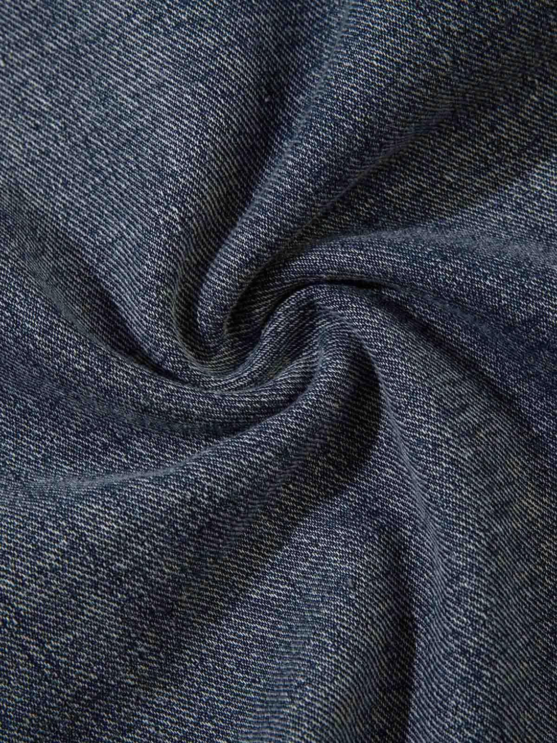 Zoomed-in texture of TALISHKO hip-hop jeans highlighting the rich denim weave.