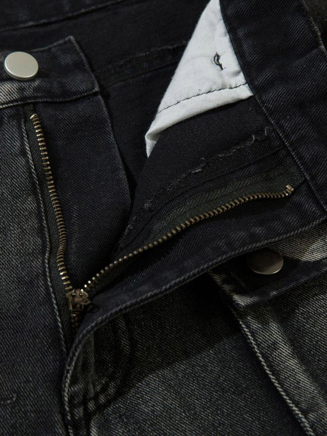 Detailed view of TALISHKO hip-hop jeans, focusing on zipper and button details.