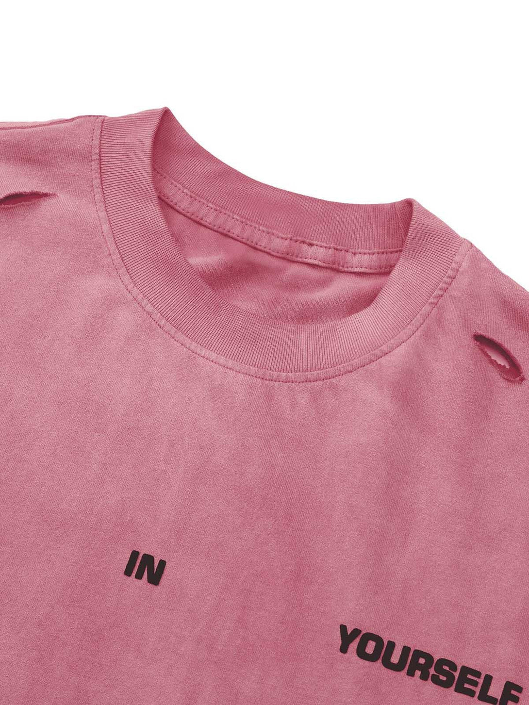 A detailed view of a pink T-shirt by TALISHKO, featuring hole accents and bold text design.