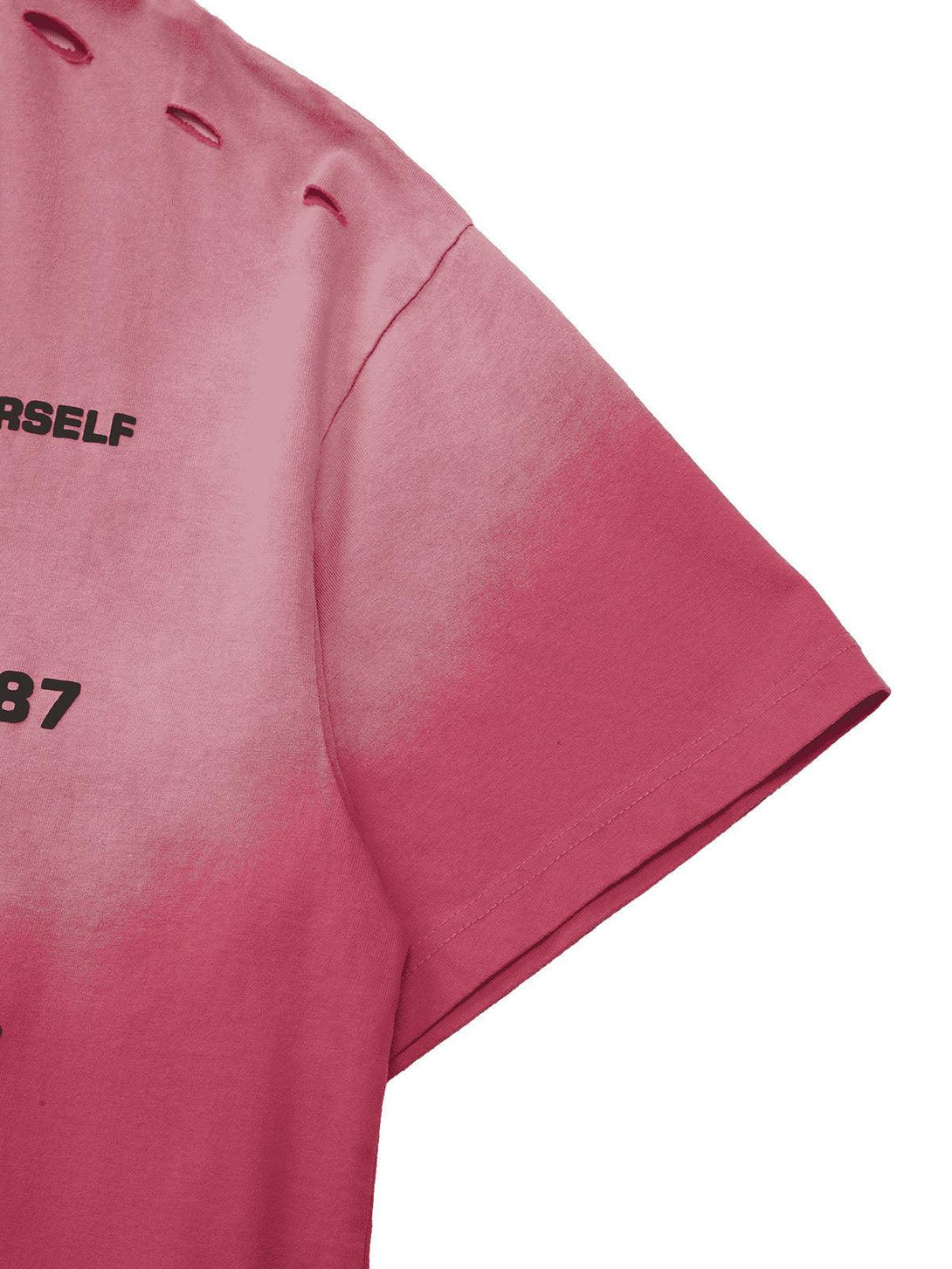 A close-up of the pink gradient T-shirt by TALISHKO, showcasing hole details and printed text.