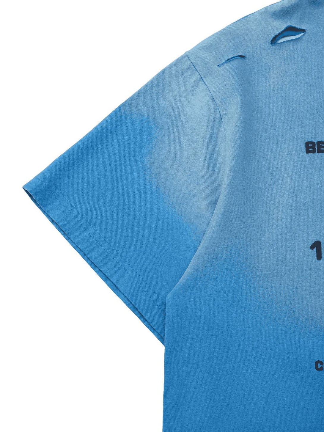 A detailed view of the blue TALISHKO T-shirt, showcasing the unique hole design and fabric texture.