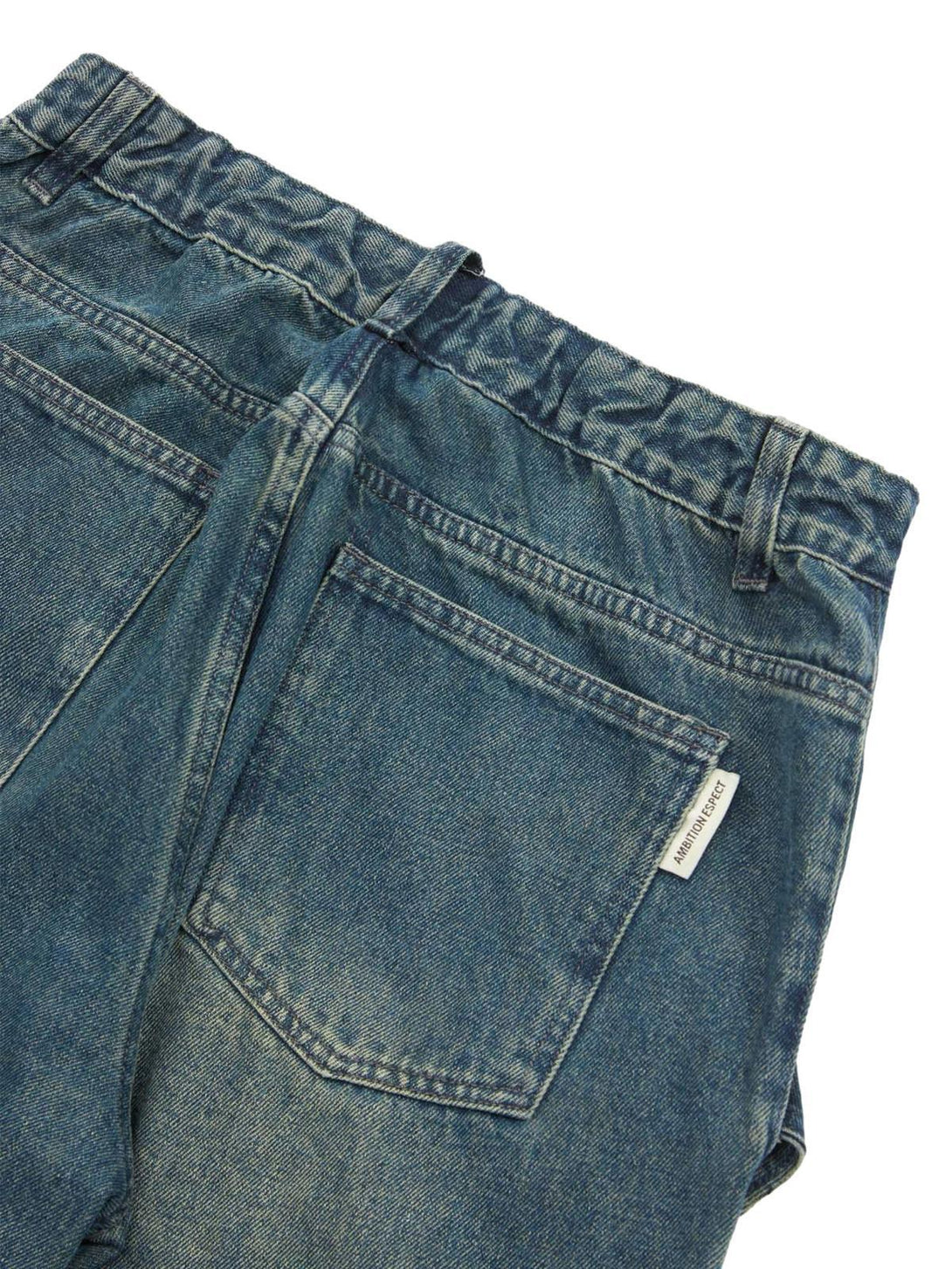 Detailed view of TALISHKO jeans' back pockets, showcasing rugged denim texture and design.