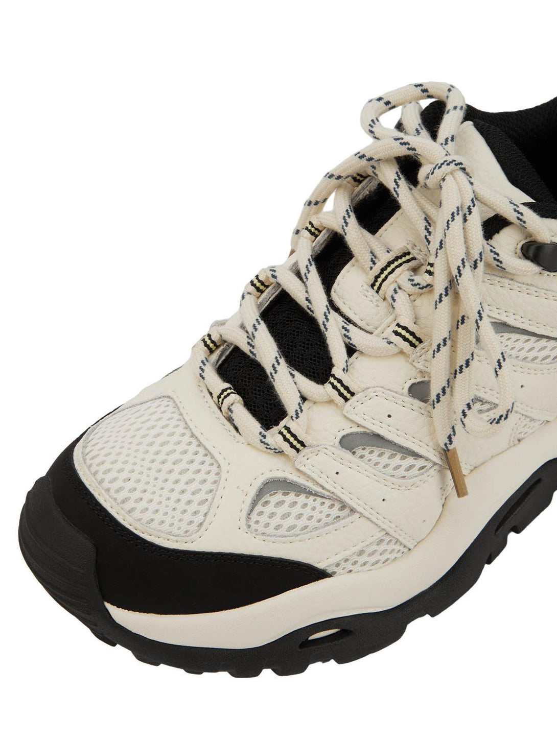 A close-up of TALISHKO hiking shoes, highlighting the intricate beige laces and black mesh detail.