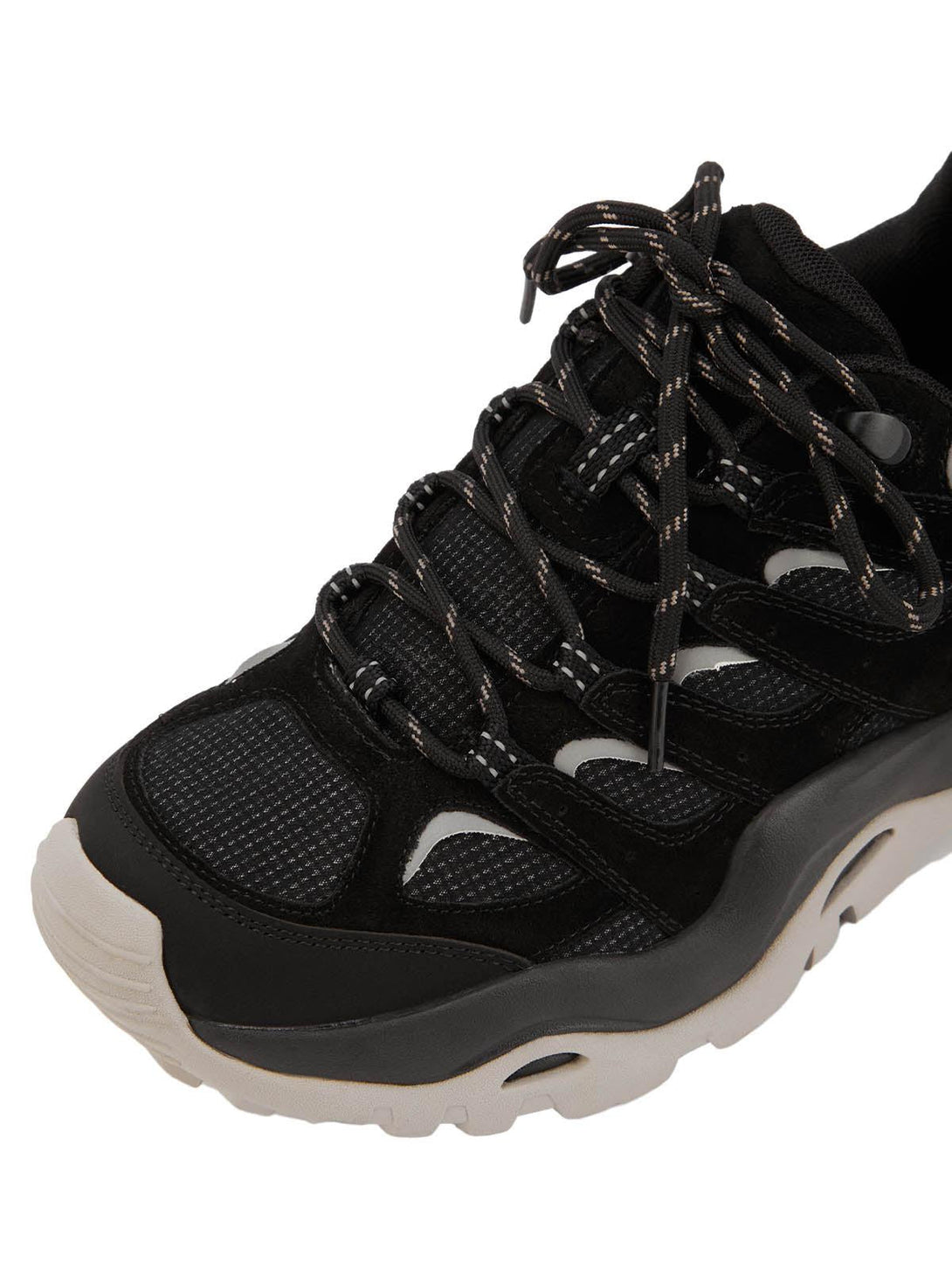 Focusing on the detailed lacing of TALISHKO hiking shoes, featuring a sleek black and white design.
