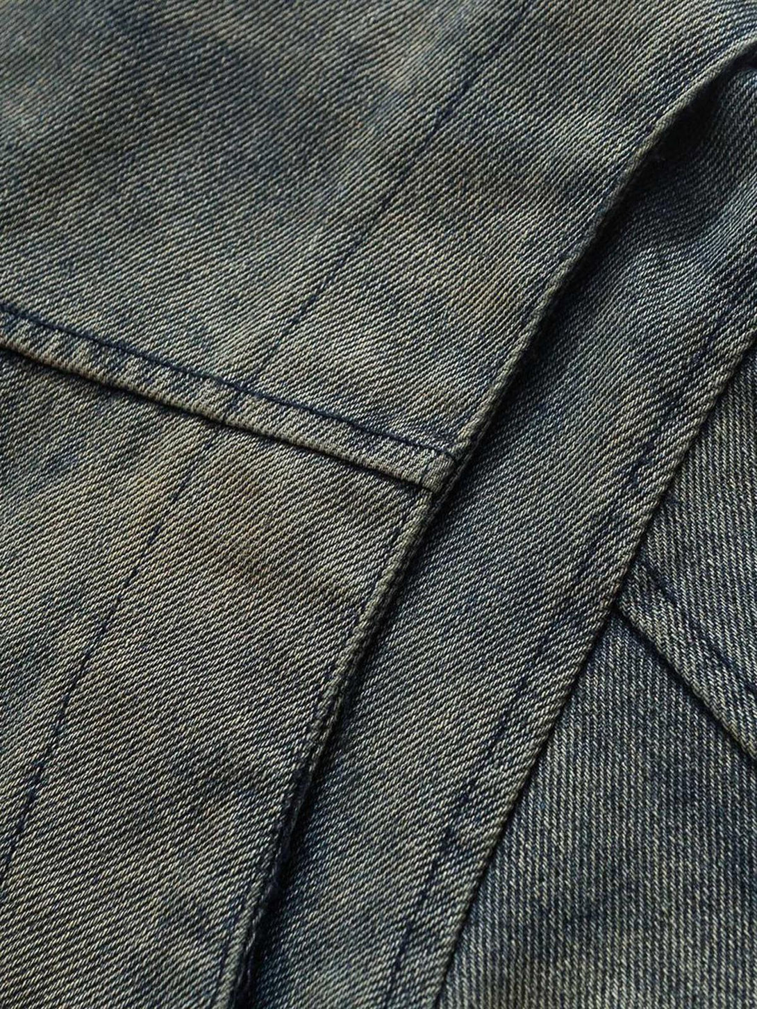 Intricate look at TALISHKO's denim jacket stitching, highlighting its textured design.