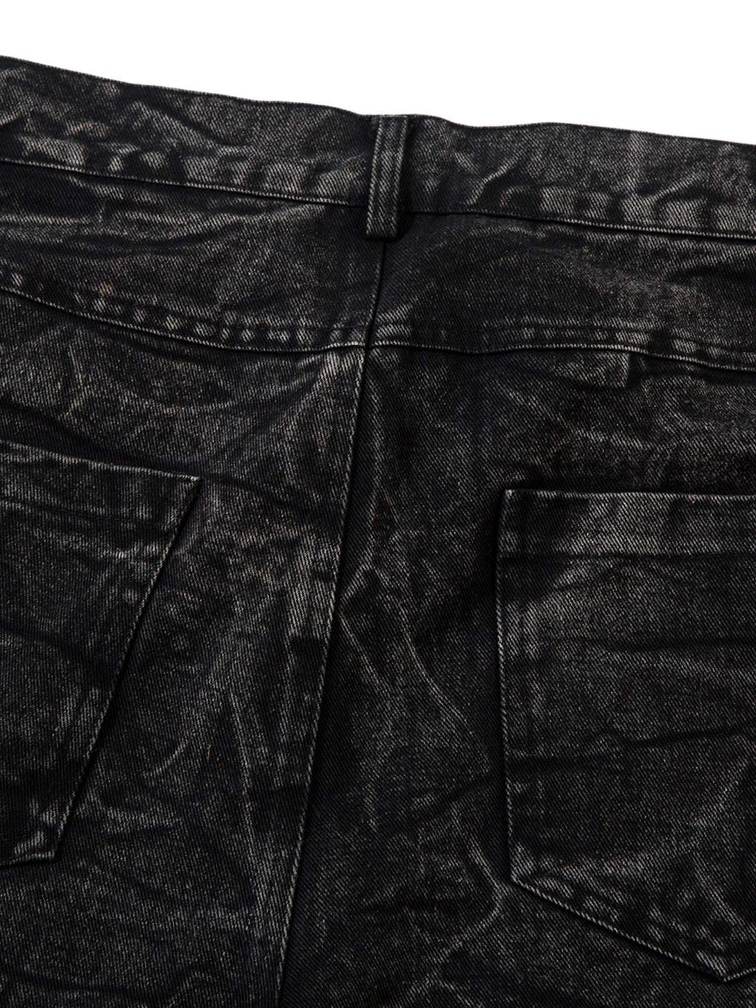 Close-up of TALISHKO distressed jeans, highlighting detailed texture and faded wash effect.