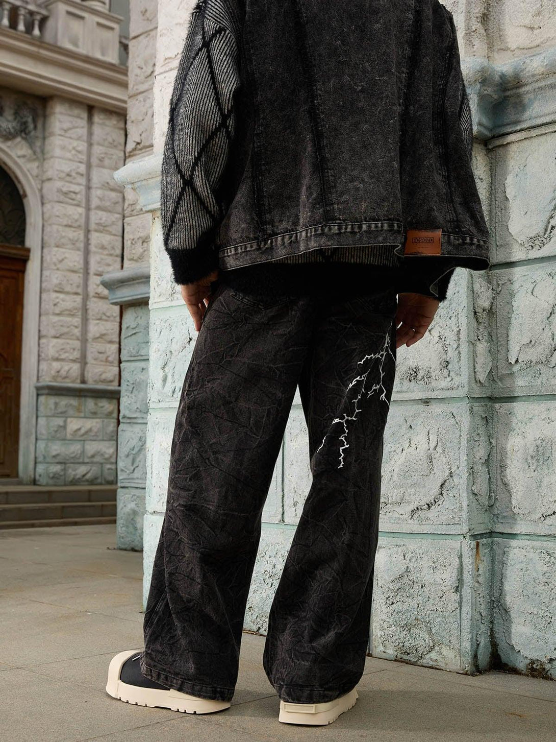 TALISHKO hip-hop jeans with distinctive white lightning detail, styled for a streetwear vibe.