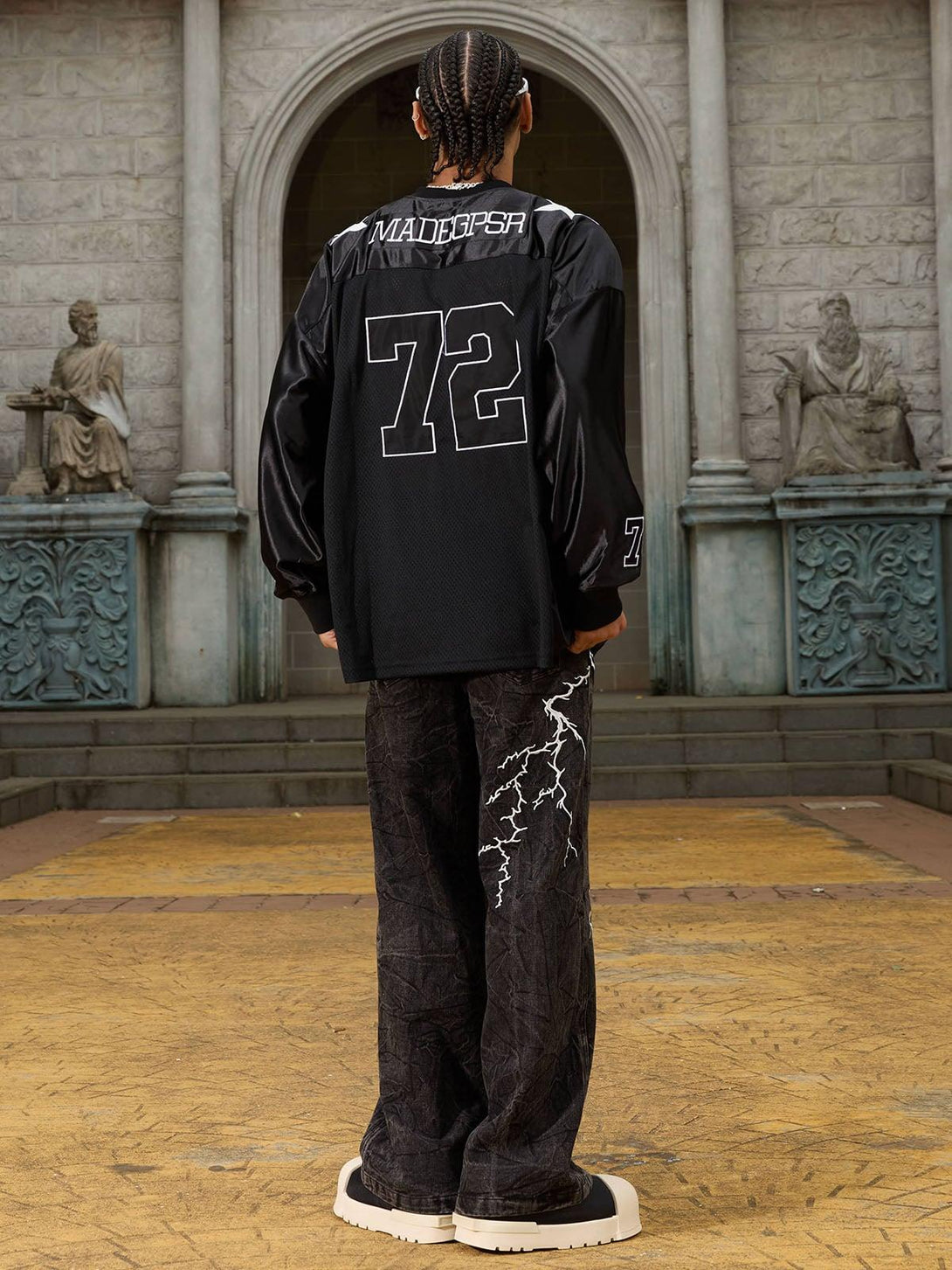 Rear view of TALISHKO hip-hop jeans with unique white lightning patterns and a relaxed fit.