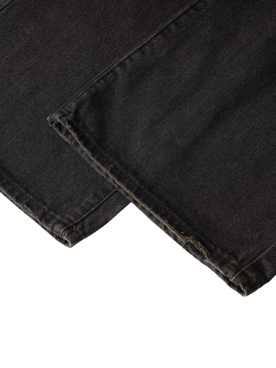 Detailed view of TALISHKO jeans' hem, highlighting the unique craftsmanship and urban style.