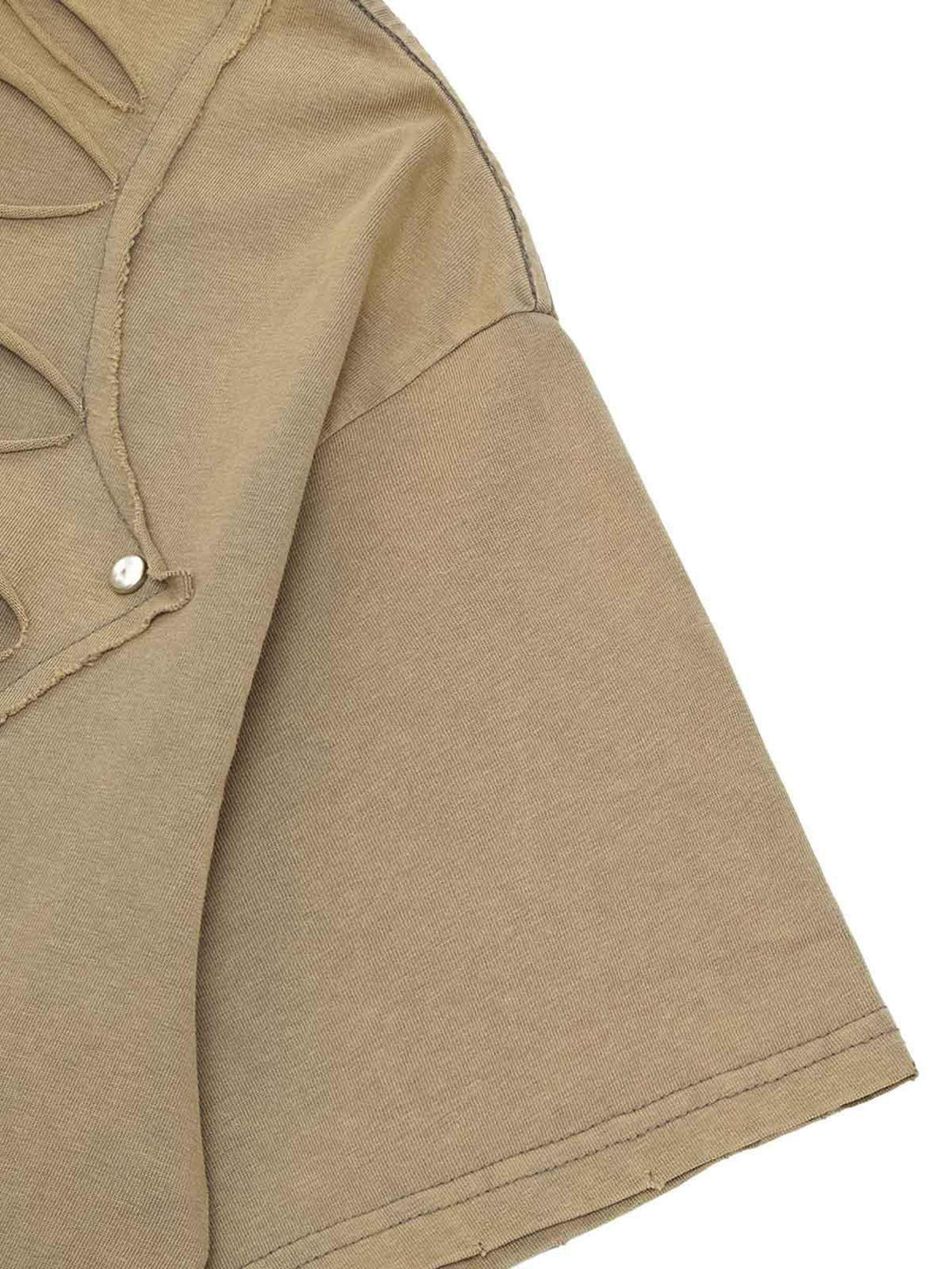 Intricate look at TALISHKO's hole design T-shirt sleeve, highlighting unique street style.