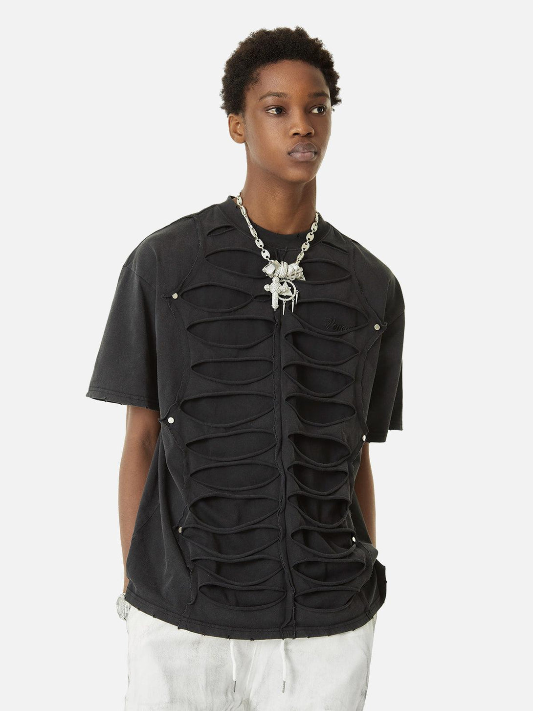 Model wearing a black TALISHKO hole design T-shirt, highlighting a high street hip hop vibe.