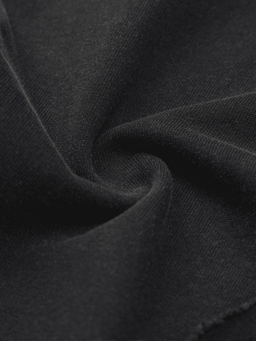 "Texture and pattern showcased in TALISHKO's T-shirt, emphasizing edgy streetwear style."