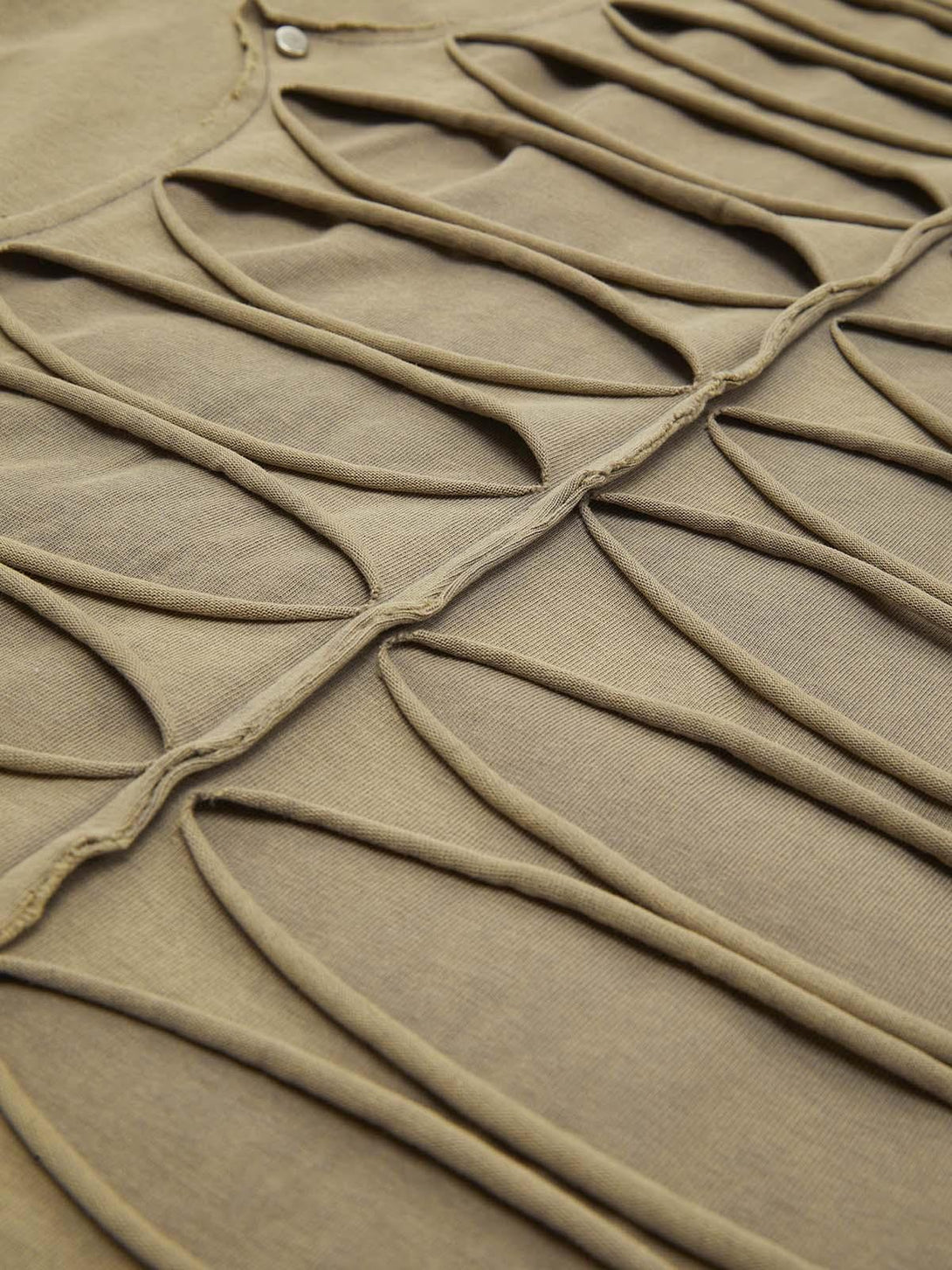 Zoomed-in texture of TALISHKO's hole design T-shirt, highlighting unique streetwear style.