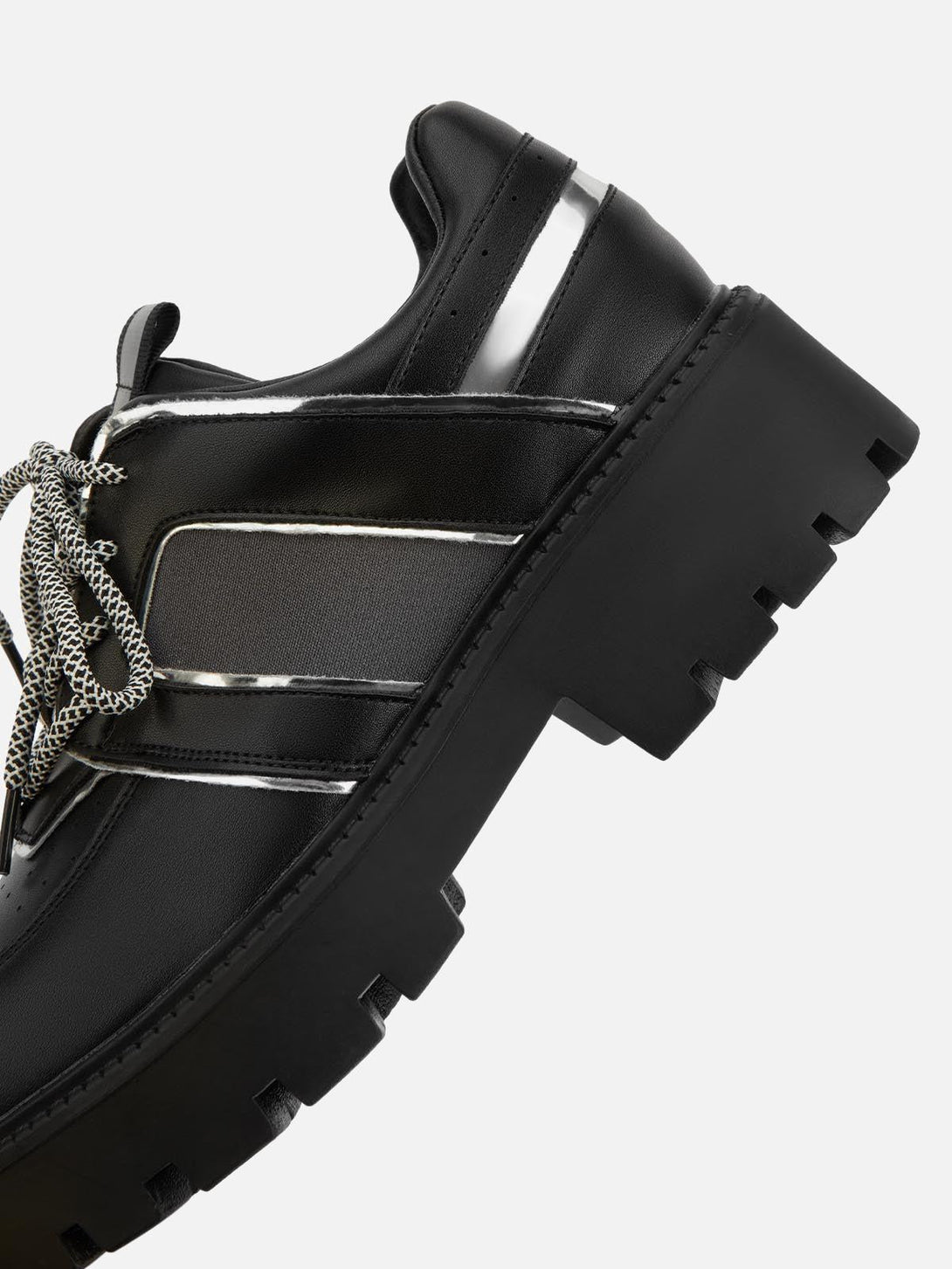 Detailed look at TALISHKO leather shoes, highlighting metal accents and thick sole design.