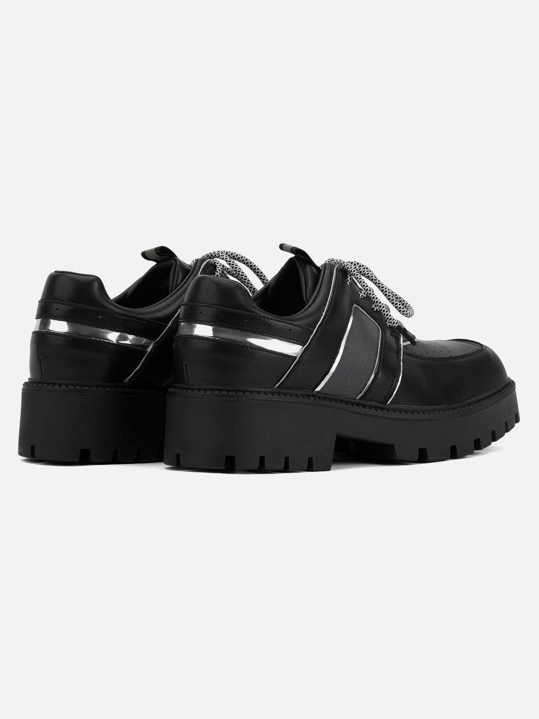 Rear view of TALISHKO leather shoes, showcasing metal accents and chunky lug soles.