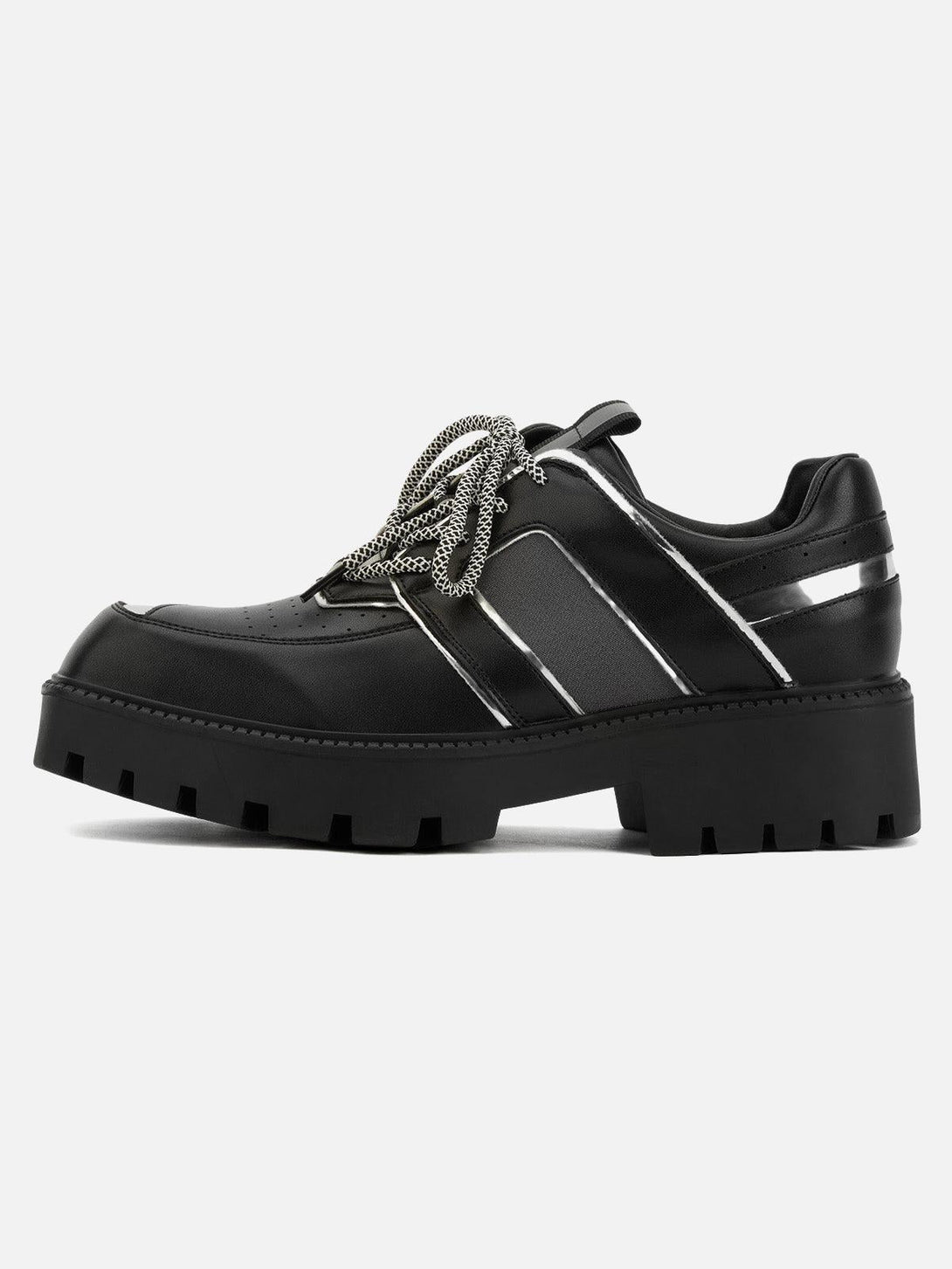 Side view of TALISHKO black leather shoes with metal accents and chunky platform soles.