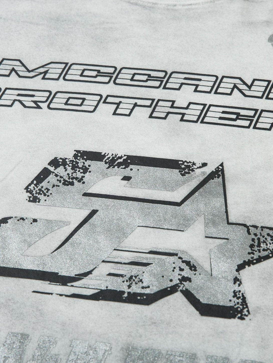 Close-up of a TALISHKO T-shirt showcasing bold graphic detail and textured design elements.