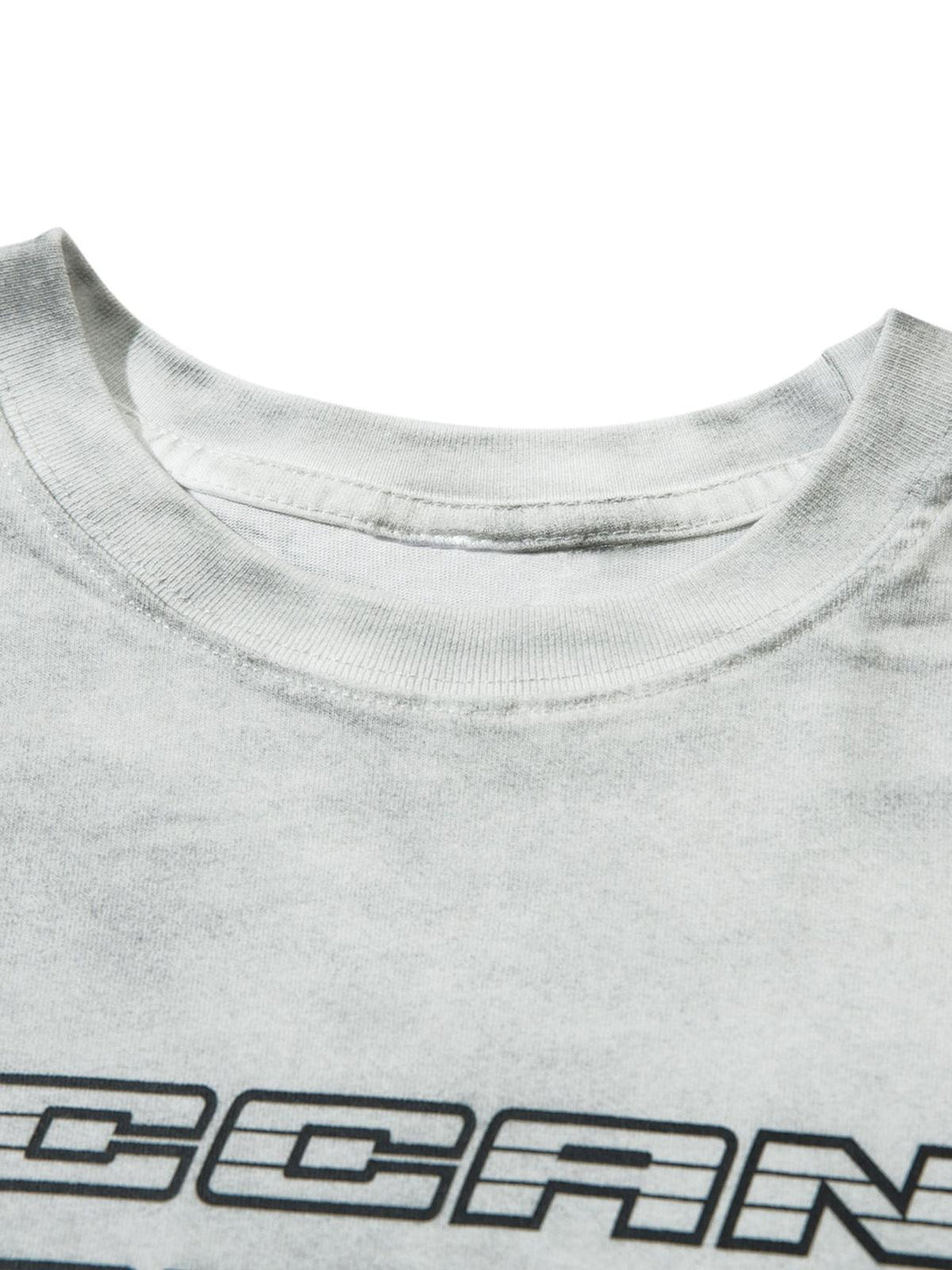 Zoomed-in view of TALISHKO T-shirt neckline with bold graphic lettering detail.