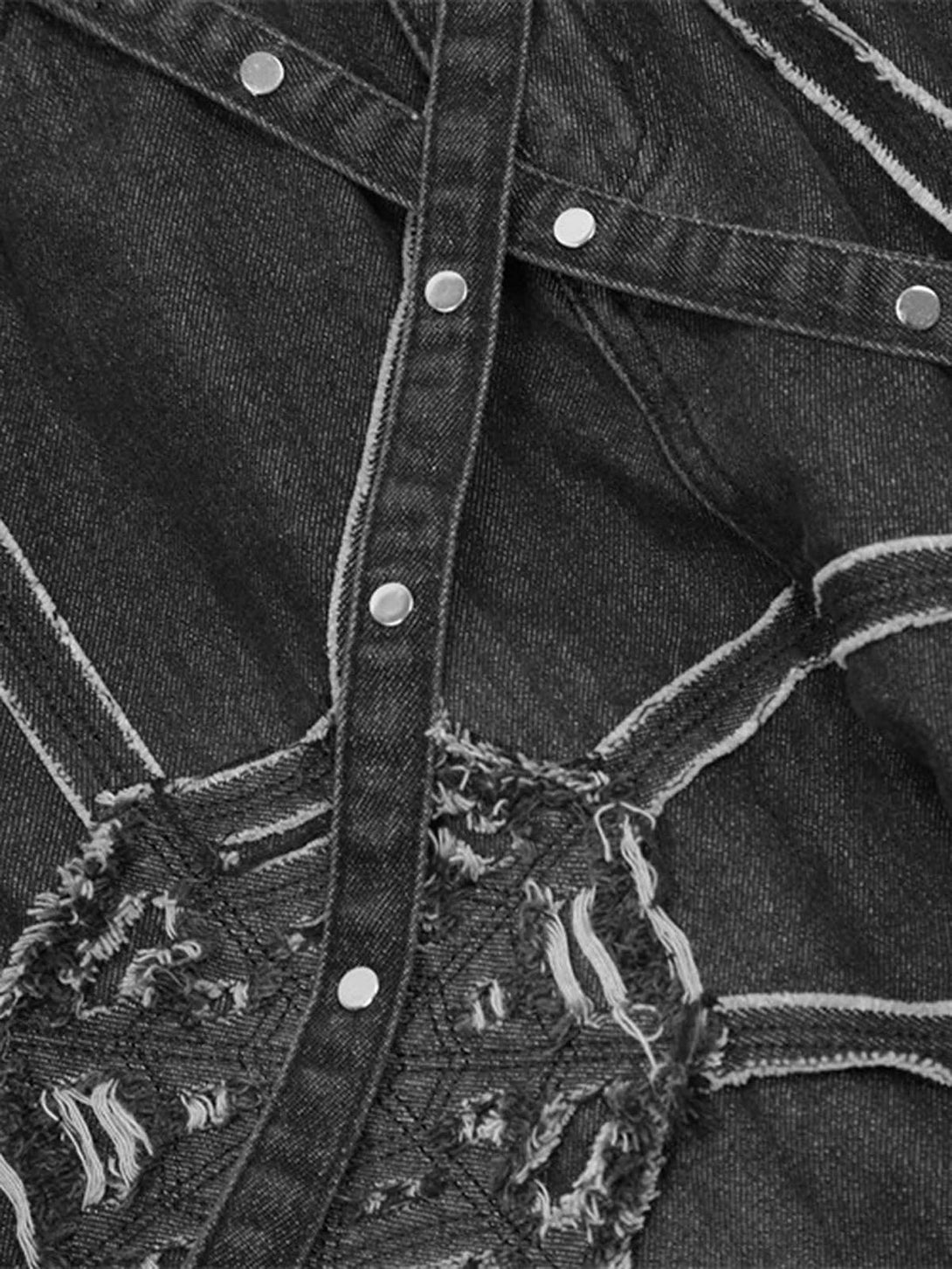 Zoomed-in texture of TALISHKO denim pants reveals unique spider web stitching and detail.