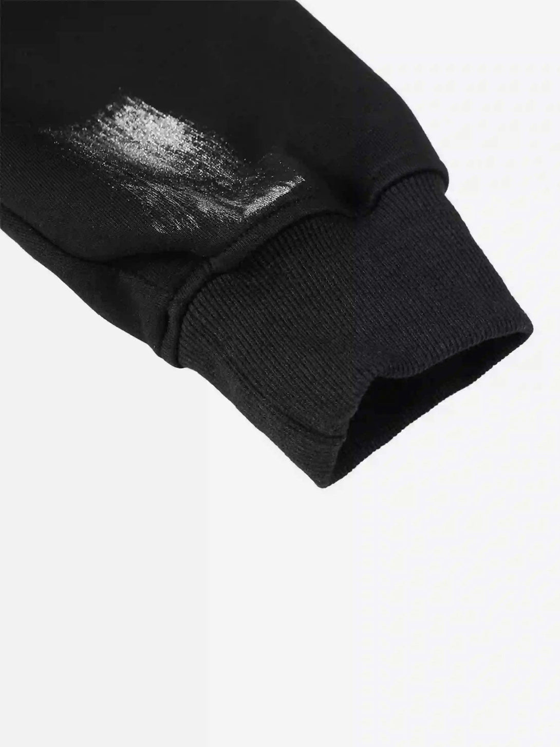 A detailed look at the TALISHKO hoodie cuff with bold brushstroke design, perfect for streetwear.