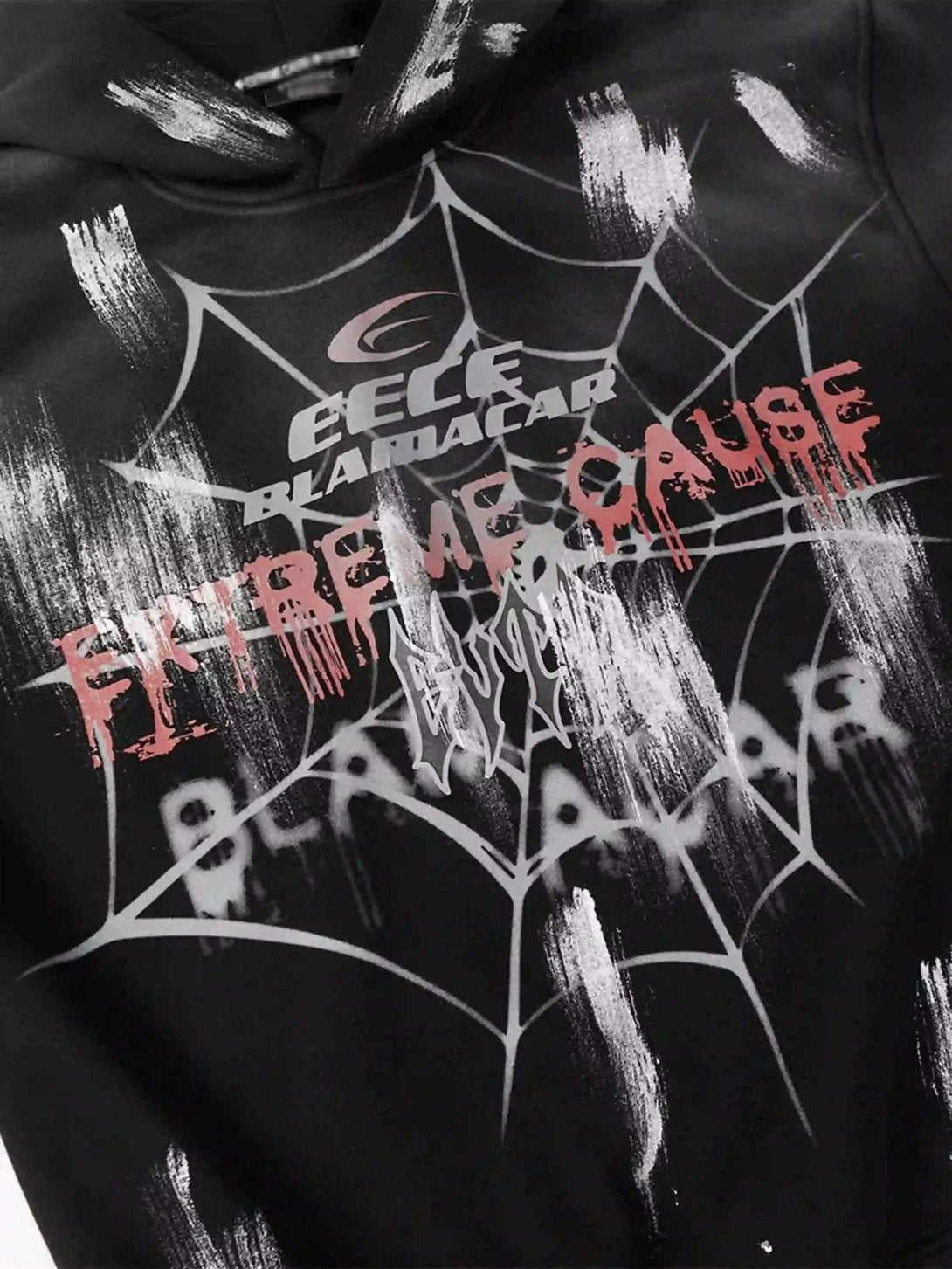 Detailed fabric and graphic print of a TALISHKO hoodie, featuring a bold spider web design.