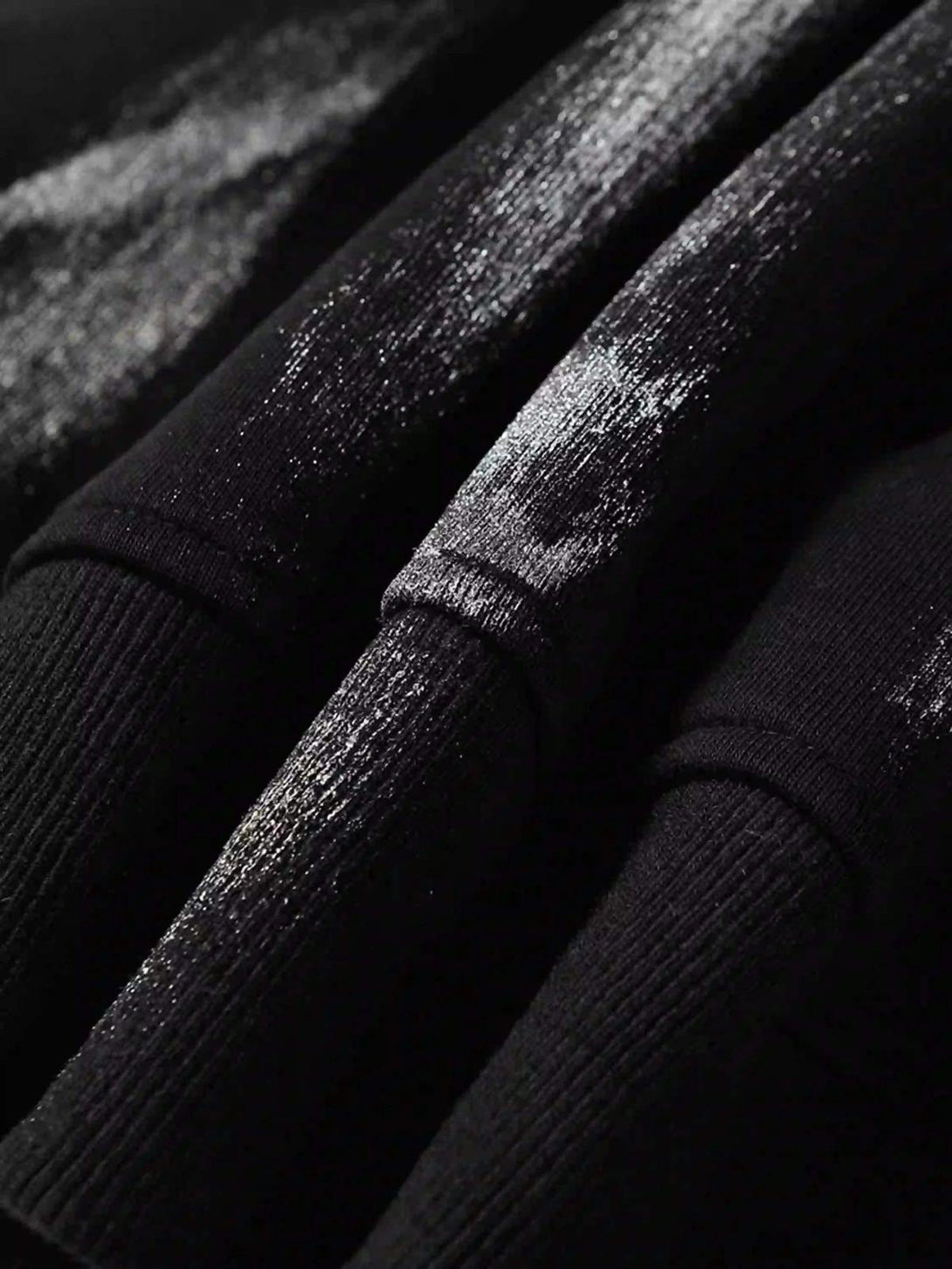 Zoomed-in texture of a TALISHKO hoodie, highlighting bold brushstrokes and intricate details.