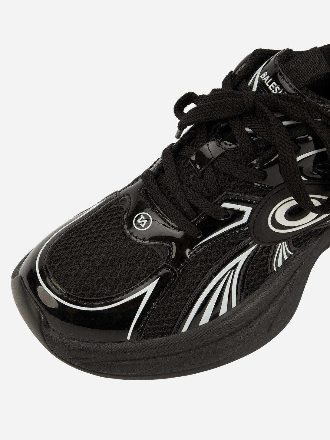 Close-up of black TALISHKO sports casual shoe featuring sleek patterns and textured mesh.