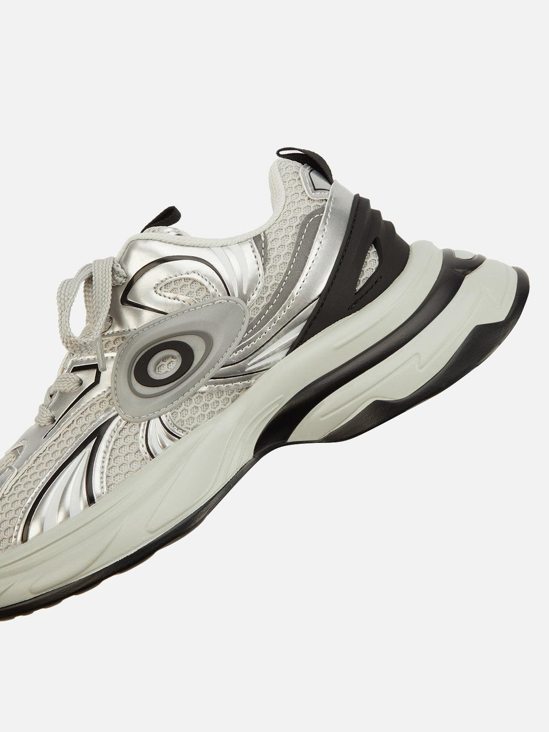 Detailed view of silver TALISHKO sneakers highlighting dynamic patterns and sleek design.