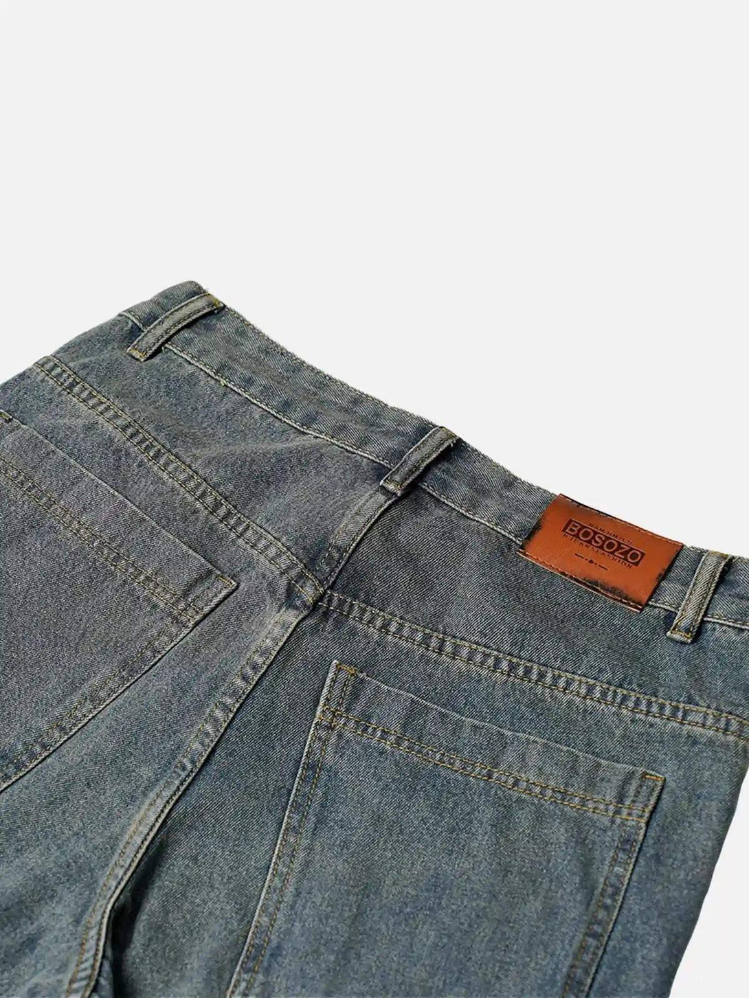 Back view of TALISHKO's washed distressed jeans, featuring unique pocket details and a leather patch.