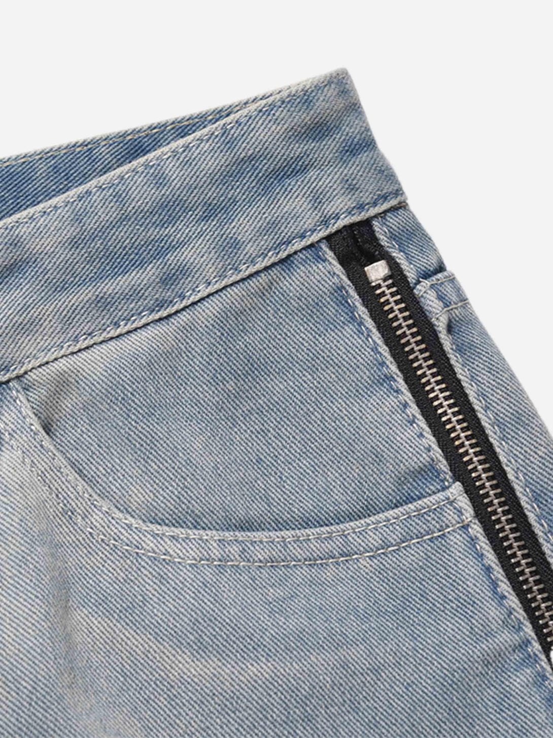 A detailed view of TALISHKO hip-hop jeans, highlighting the zipper and stitching design.
