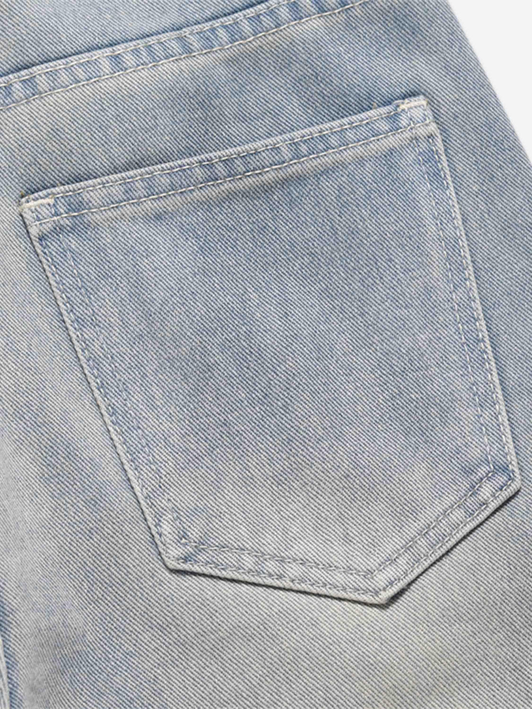 Detailed look at the back pocket of TALISHKO hip-hop jeans, showcasing intricate stitching.