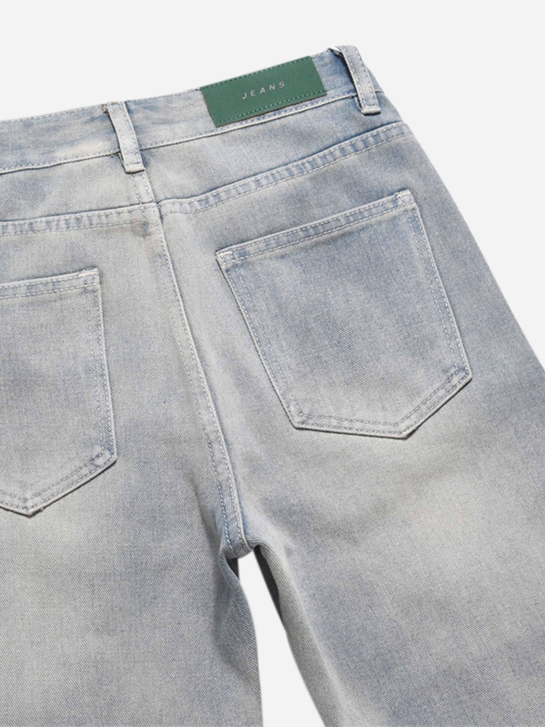 Back view of TALISHKO straight jeans, highlighting pockets and casual denim style.