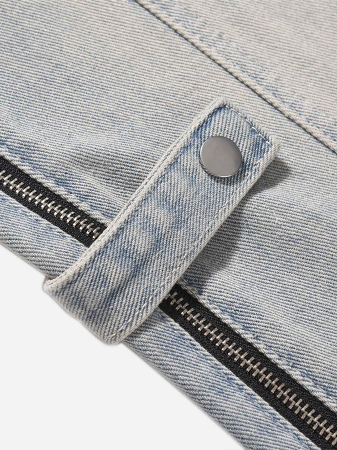 A close-up of TALISHKO's hip-hop jeans, highlighting the denim texture and metal snap detail.