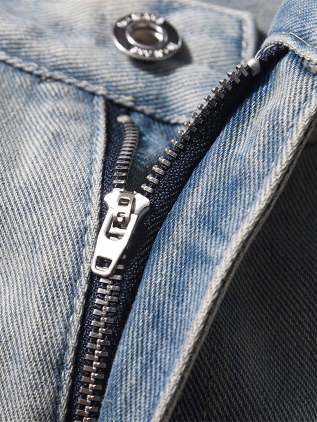 Detailed fabric and zipper design of TALISHKO hip-hop jeans, showcasing urban street style.