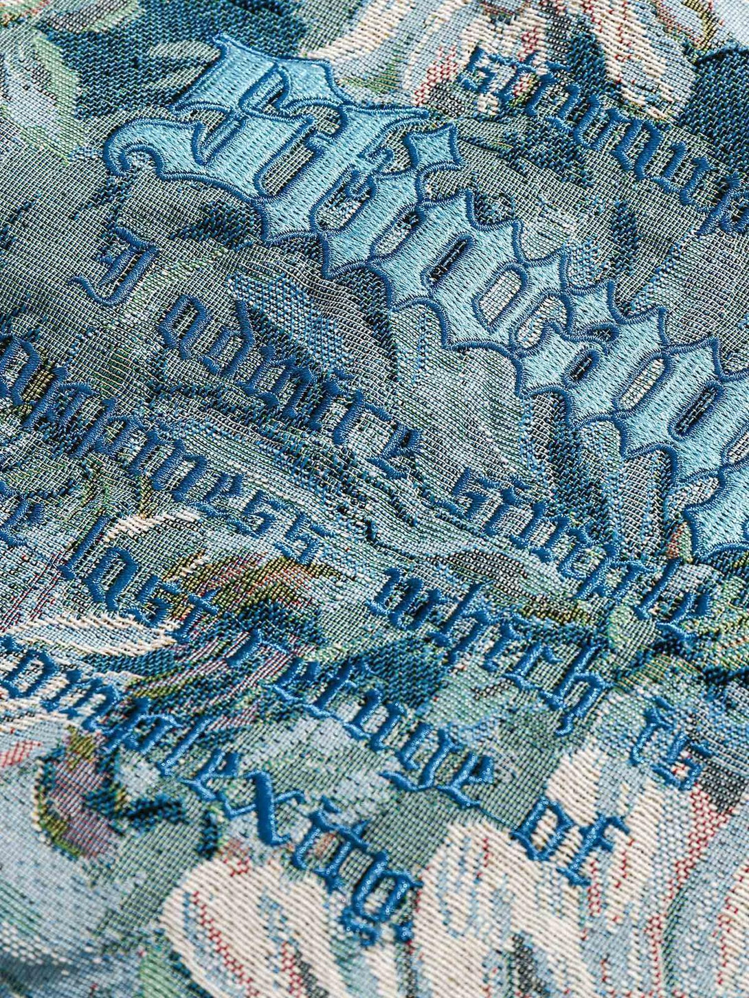 Intricate embroidery detail on a TALISHKO jacquard jacket, showcasing ornate stitching and texture.