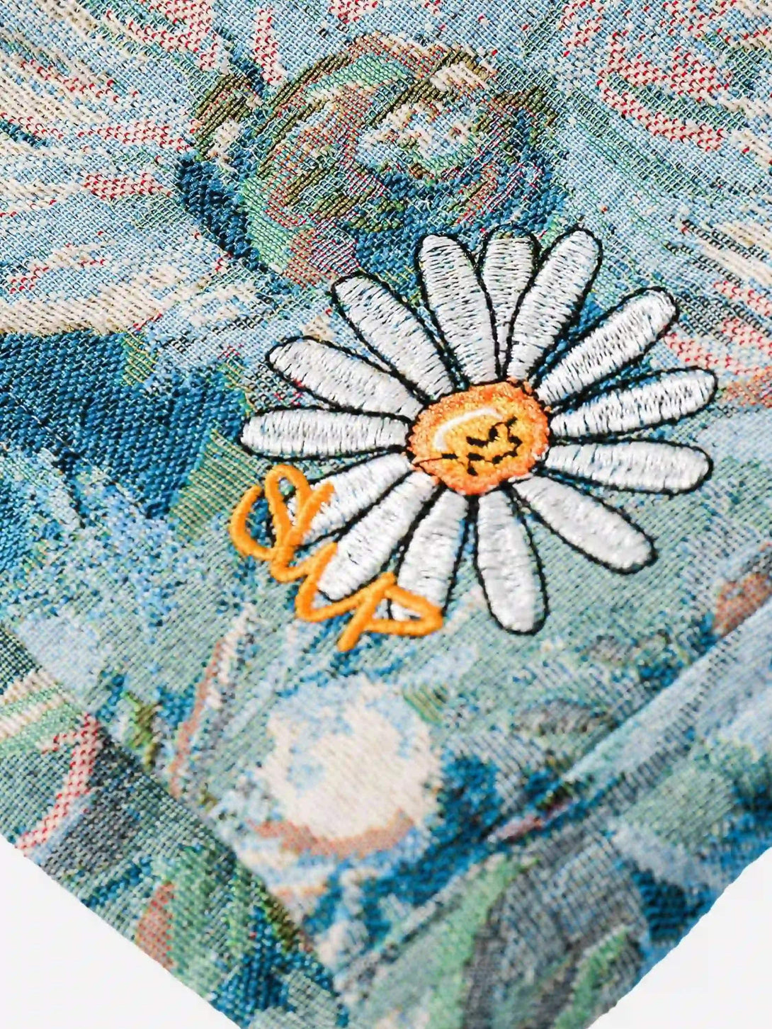 A detailed view of TALISHKO's jacquard embroidery, showcasing floral design and texture.
