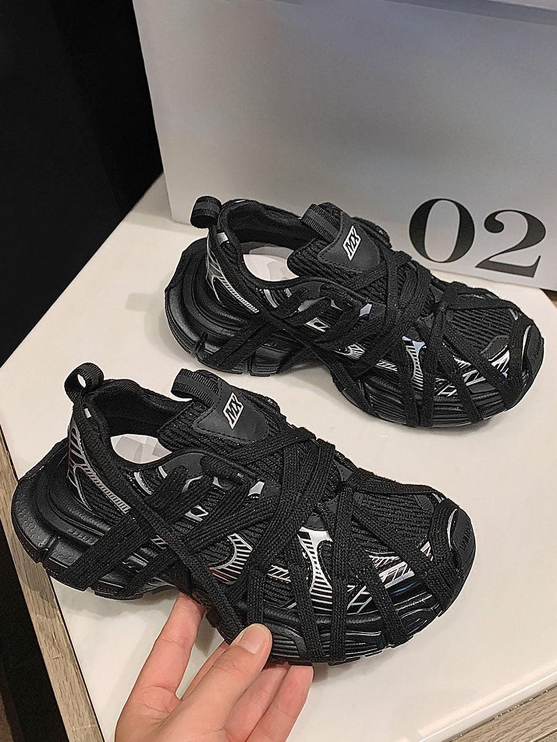 TALISHKO black lace-up casual sneakers with unique design, perfect for a modern street style.