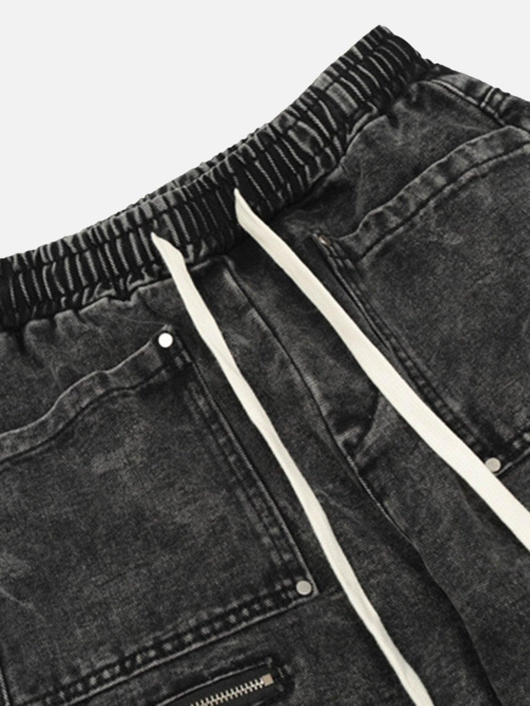 A detailed view of TALISHKO's loose drawstring trousers, showcasing fabric texture and pockets.