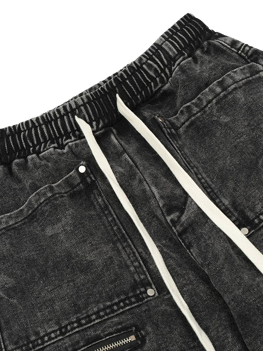 A detailed look at TALISHKO's drawstring trousers, highlighting the elastic waist and pockets.