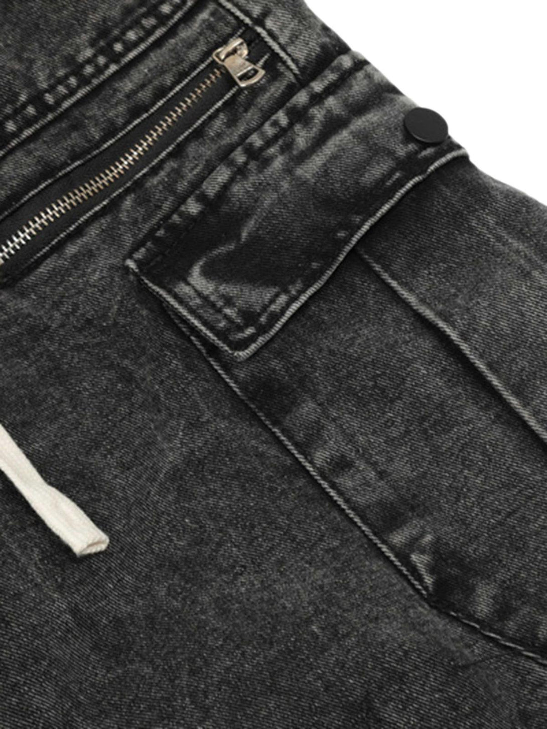 A close-up of TALISHKO's black loose trousers, highlighting the zip and pocket detail.