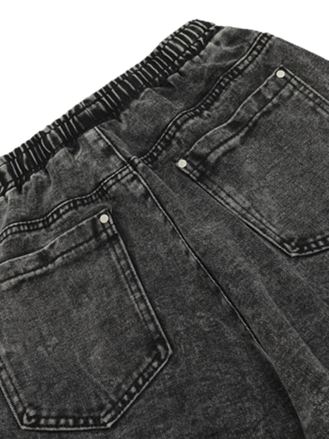 Back view of TALISHKO's dark wash loose trousers, highlighting elastic waist and pockets.