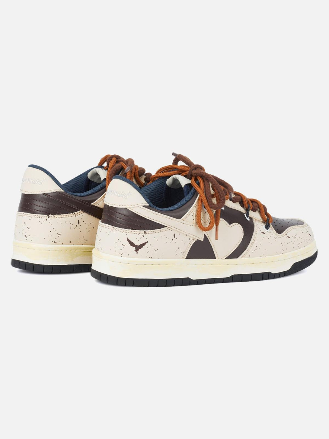 Rear view of TALISHKO sneakers in cream and brown, featuring heart design and bold laces.
