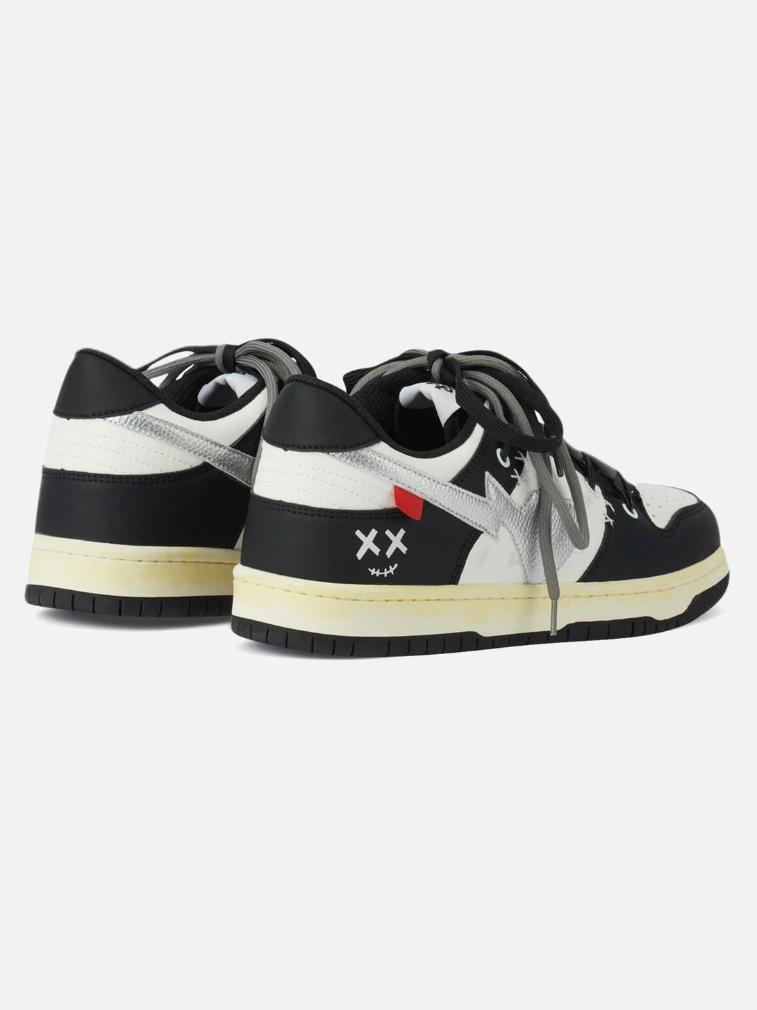 Rear view of TALISHKO sneakers, highlighting black and white design with unique details.