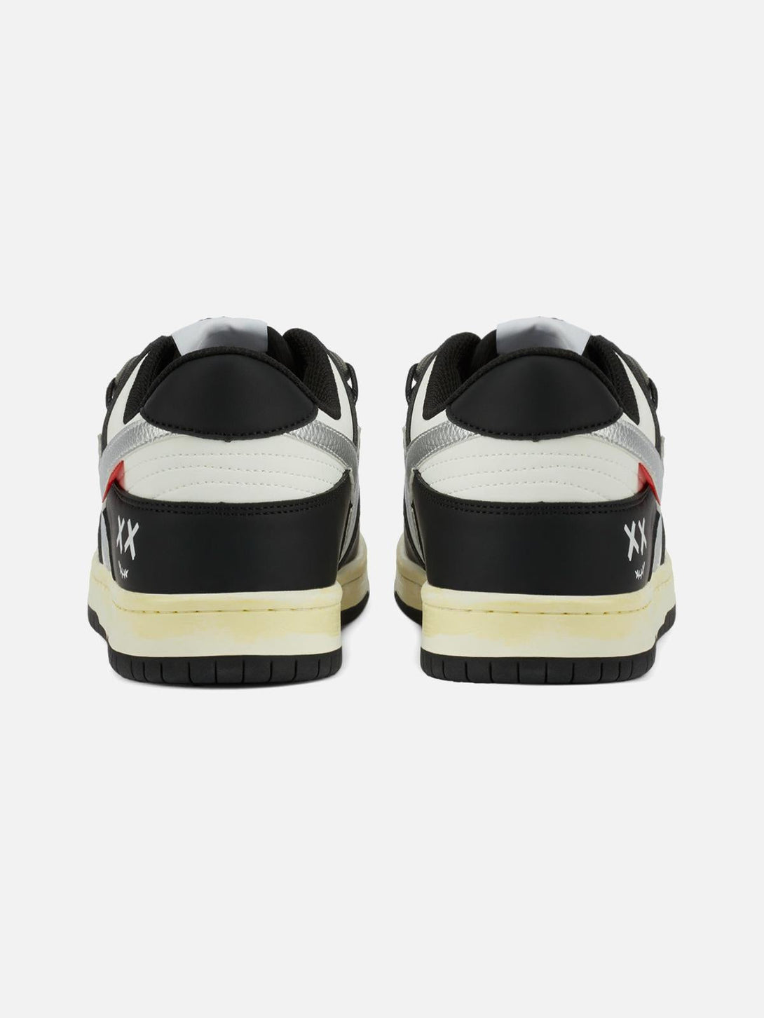 Rear view of TALISHKO sneakers, featuring black and white design with distinctive "XX" detail.