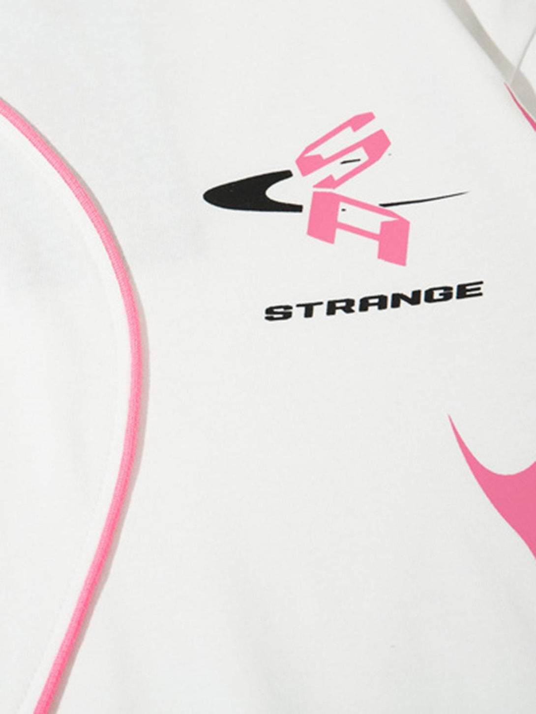 Zoomed-in view of graphic design on a white TALISHKO asymmetric T-shirt with pink accents.