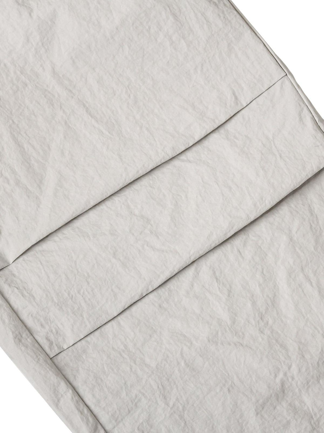 Detailed fabric and stitching of TALISHKO cargo pants, emphasizing texture and quality.